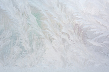Frost on glass. Background. Frosty pattern on a glass surface. Low temperatures. Seasons. January frost.