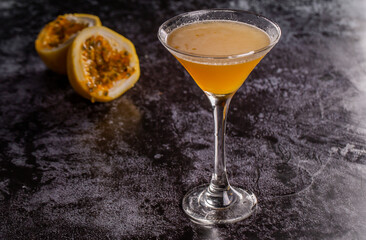Elegant yellow passion fruit cocktail in martini glass