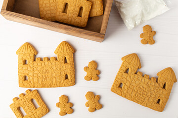 Christmas house from ginger cookies with ginger man outside decorated in Christmas