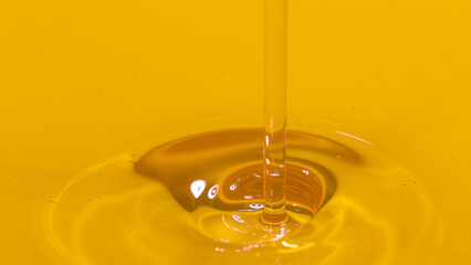 MACRO: Cinematic shot of unrefined walnut oil getting poured into a container. - obrazy, fototapety, plakaty
