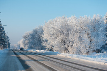 Obraz premium Winter road. Russian nature. Lots of snow all around. Travel in the cold. Winter road through the forest.