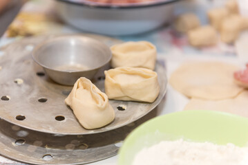 Manti with meat. National traditional food. Dough with meat. Russian food. Manti on a plate. Cook dinner.