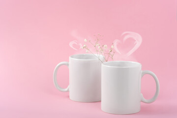 Mockup white coffe two cups or mug on a pink background with copy space. Blank template for your design, branding, business. Real photo. Hot drink steam in the form of hearts