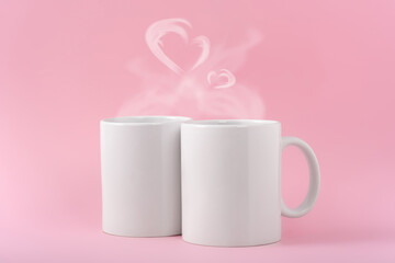 Mockup white coffe two cups or mug on a pink background with copy space. Blank template for your design, branding, business. Real photo. Hot drink steam in the form of hearts