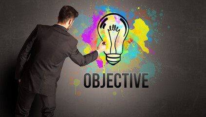 businessman drawing colorful light bulb