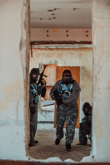 Photo of a paintball team in action with professional equipment.Selective focus