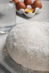 Dough on white marble board, closeup. Sodawater bread recipe