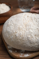 Dough on wooden table, closeup. Sodawater bread recipe