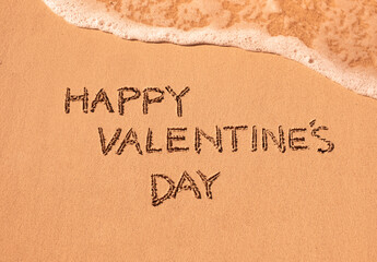 Happy Valentine's Day written on the sand