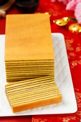 Lapis Legit or Thousand Layers Cake on White Plate. Chinese new year Red Concept