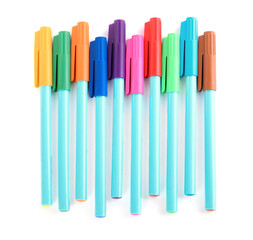 Many colorful markers on white background, top view. School stationery