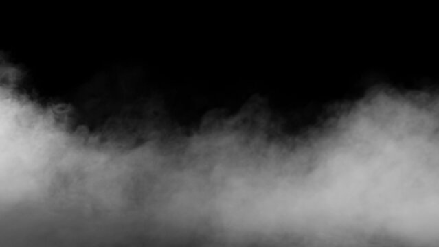 Misty fog effect texture overlays for text or space. Smoke on floor. Isolated black background. White clouds of vapor smoke. Gas explodes, swirl and dances in space. Explosion smoke bomb. dry ice.