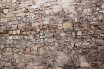 The texture of the stone wall. Old castle stone wall texture background. Stone wall as background or texture. Fragment of stone wall for background or texture