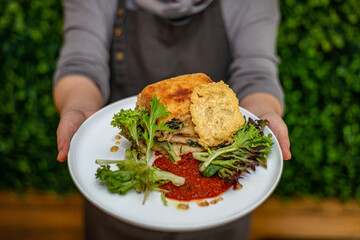 person holding a bowl of food