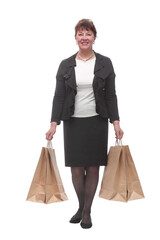 Mature woman holding shopping bags smiling and looking at camera