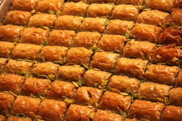 colorful delicious baklava dessert on counter of shop, grocery, market, cafe - close up view. Dessert, sale, sweet food and confectionery concept