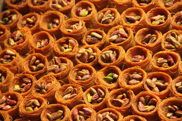 colorful delicious baklava dessert on counter of shop, grocery, market, cafe - close up view. Dessert, sale, sweet food and confectionery concept