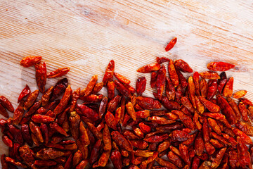 Image of dry cayenne pepper on wooden surface in home kitchen