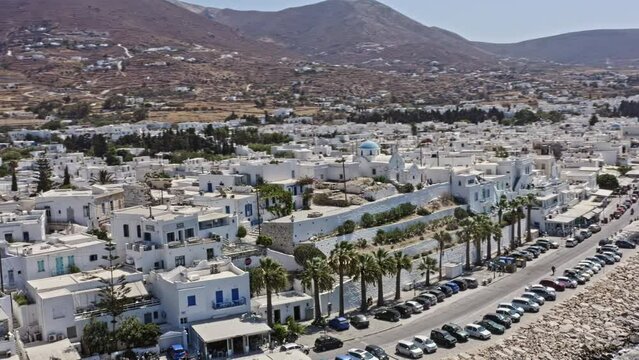 Parikia Paros Greece Aerial v4 low level drone fly around intown capturing beautiful summer waterfront greek style townscape and ferry and boats docked at the harbor - September 2021