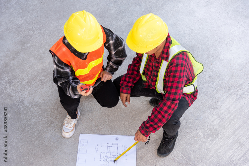 Aufkleber architect and client discuss help create plan with blueprint of the building at construction site fl