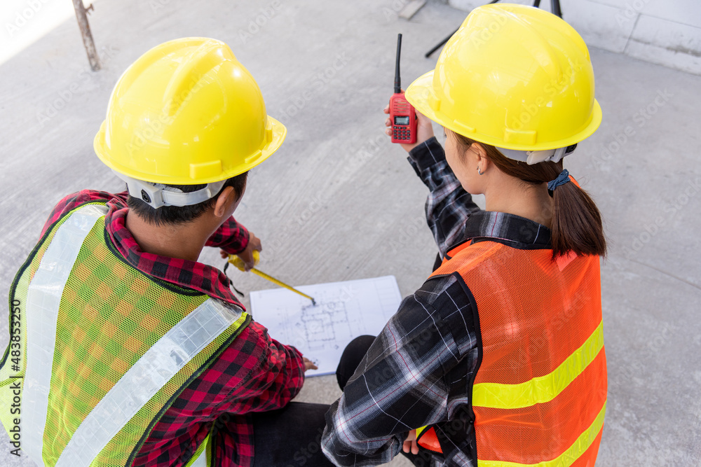 Aufkleber architect and client discuss help create plan with blueprint of the building at construction site fl
