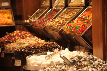 colorful delicious marmalade jelly candies on counter of shop, grocery, market, cafe - close up view. Dessert, sale, sweet food and confectionery concept