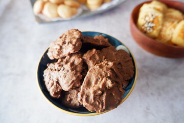 homemade chocolate cookies in a bowl, on a gray background. snacks, biscuits, made from flour, eggs, and sugar are eaten at tea time. snack time. close up