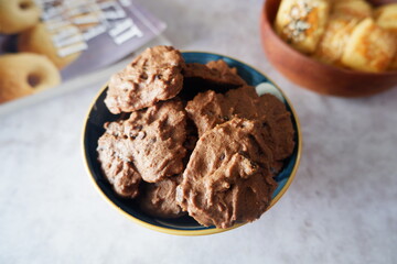 homemade chocolate cookies in a bowl, on a gray background. snacks, biscuits, made from flour, eggs, and sugar are eaten at tea time. snack time. close up
