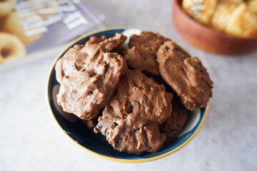 homemade chocolate cookies in a bowl, on a gray background. snacks, biscuits, made from flour, eggs, and sugar are eaten at tea time. snack time. close up