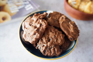 homemade chocolate cookies in a bowl, on a gray background. snacks, biscuits, made from flour, eggs, and sugar are eaten at tea time. snack time. close up
