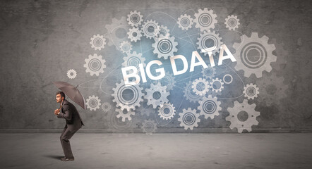 Businessman defending with umbrella