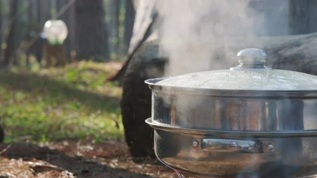 Cooking in nature camping outdoor. cooker prepare breakfast picnic on a portable camp stove. campsite lifestyle.