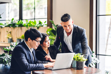 Group of business colleague team discussing meeting strategy sharing idea with marketing job project.Creative business people work with laptop computer in green plant terrace decorated workloft