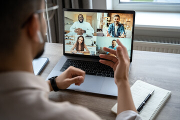 Fototapeta na wymiar Back view of man having virtual training on video call meeting, online webinar