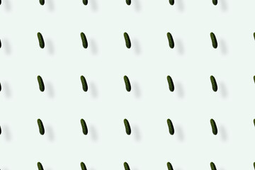 Colorful pattern of fresh cucumbers on white background with shadows. Top view. Flat lay. Pop art design