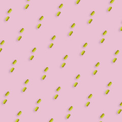Colorful pattern of yellow kitchen sponges on pink background. Top view. Flat lay. Pop art design