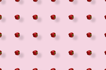 Colorful pattern of fresh paprika on pink background with shadows. Bulgarian red pepper. Top view. Flat lay. Pop art design