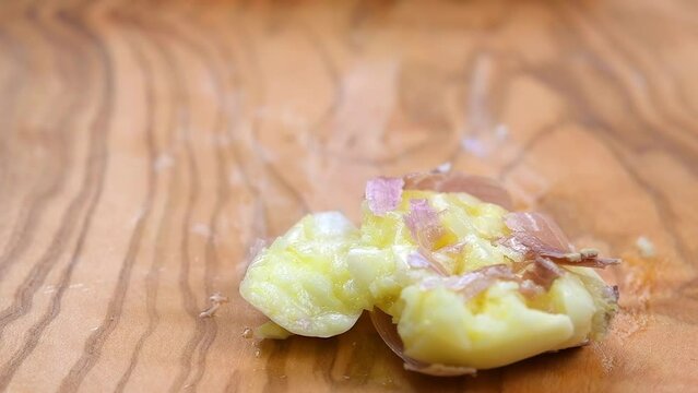 Crushing a garlic clove food ingredient. SLOW MOTION