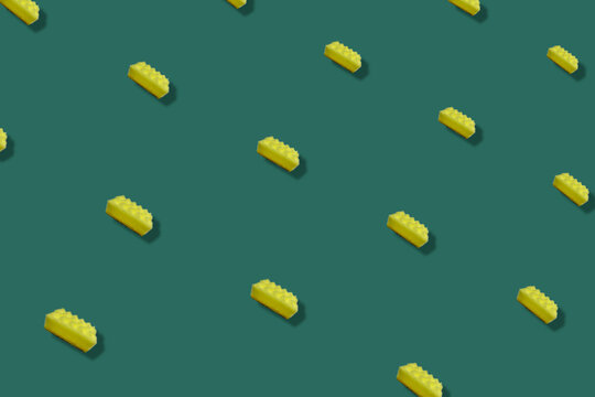 Colorful Pattern Of Yellow Kitchen Sponges On Green Background With Shadows. Top View. Flat Lay. Pop Art Design