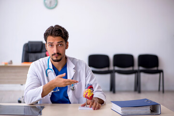Young male doctor cardiologist working in the clinic