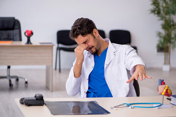 Young male doctor cardiologist working in the clinic