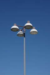 Streetlights on a high mast at a large shopping center parking lot