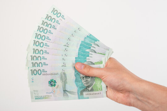 Hand holding colombian money