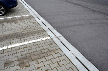 Fototapeta premium drainage element in interlocking paving concrete gutter with slotted drain from one piece of concrete can hold water from the parking lot along the entire length of the yard