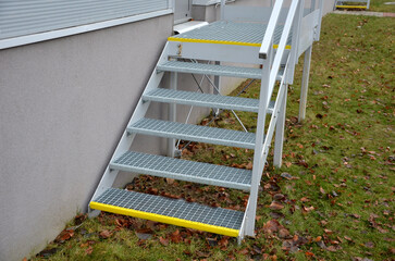 industrial hall, warehouse has a side door at a steep staircase with high resistance even under...