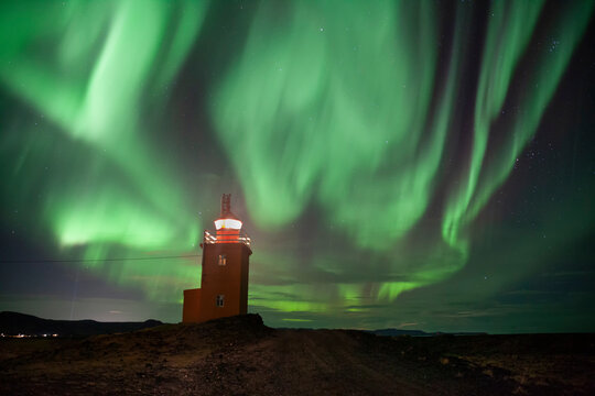 Incredible Aurora Borealis at the Hopsnes Lighthouse in Iceland.Powerful Northern Lights