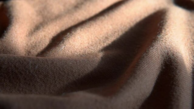Wool cashmere background. Soft, brown, camel, woolen, merino clothes texture, fabric sweater closeup. Textile, linen, fiber material pattern for handcraft knitting. Winter, warm, wear fashion.