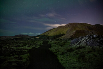 Obraz na płótnie Canvas Ancient Lava fields in Iceland beside Þorbjörn mountain and the Blue Lagoon at night.