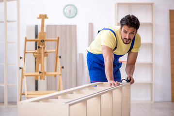 Young male carpenter working at home