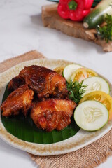 a plate of chicken roasted with vegetables 